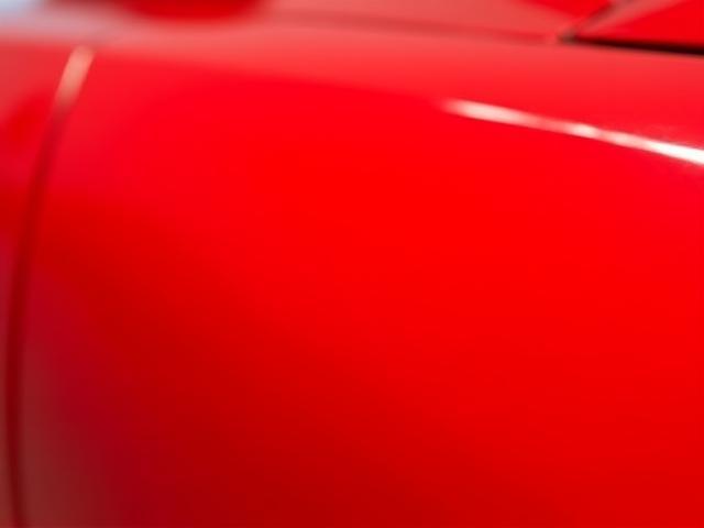 Vibrant red car paint after polishing and waxing